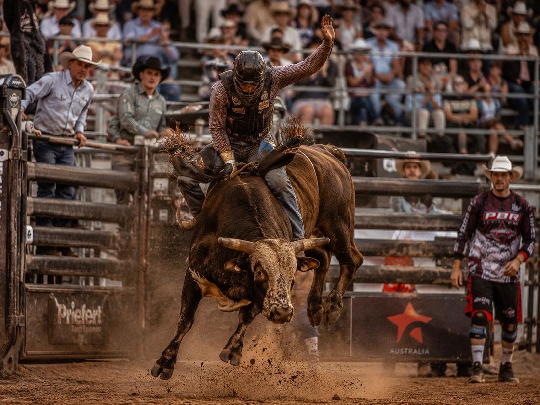 Bull rider in a dusty rodeo arena